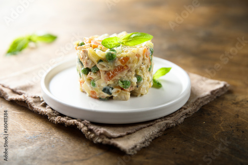 Traditional homemade Olivier salad on a white plate