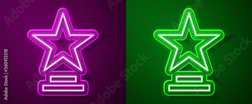 Glowing neon line Movie trophy icon isolated on purple and green background. Academy award icon. Films and cinema symbol. Vector Illustration.