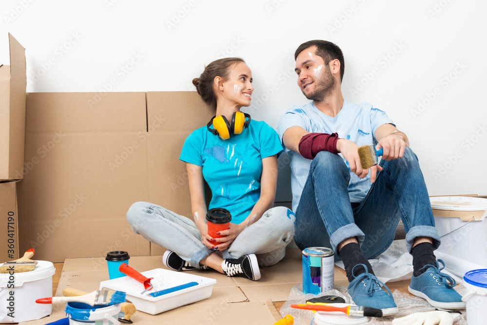 Happy smiling couple relaxing on floor Happy smiling couple relaxing on floor