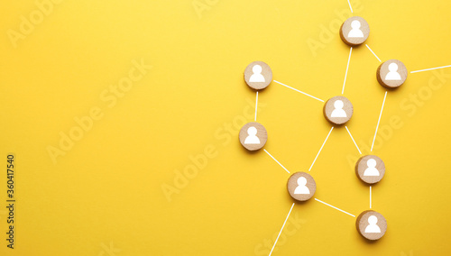 Abstract teamwork, network and community concept on a yellow paper background