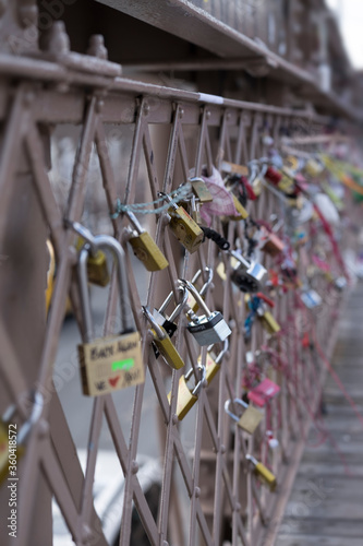 Love locks at the Brooklyn Bridge in New York with narrow depth of field photo