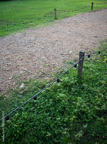 Wallpaper Mural Gravel walking path in a grass field/lawn with light bulb fence Torontodigital.ca