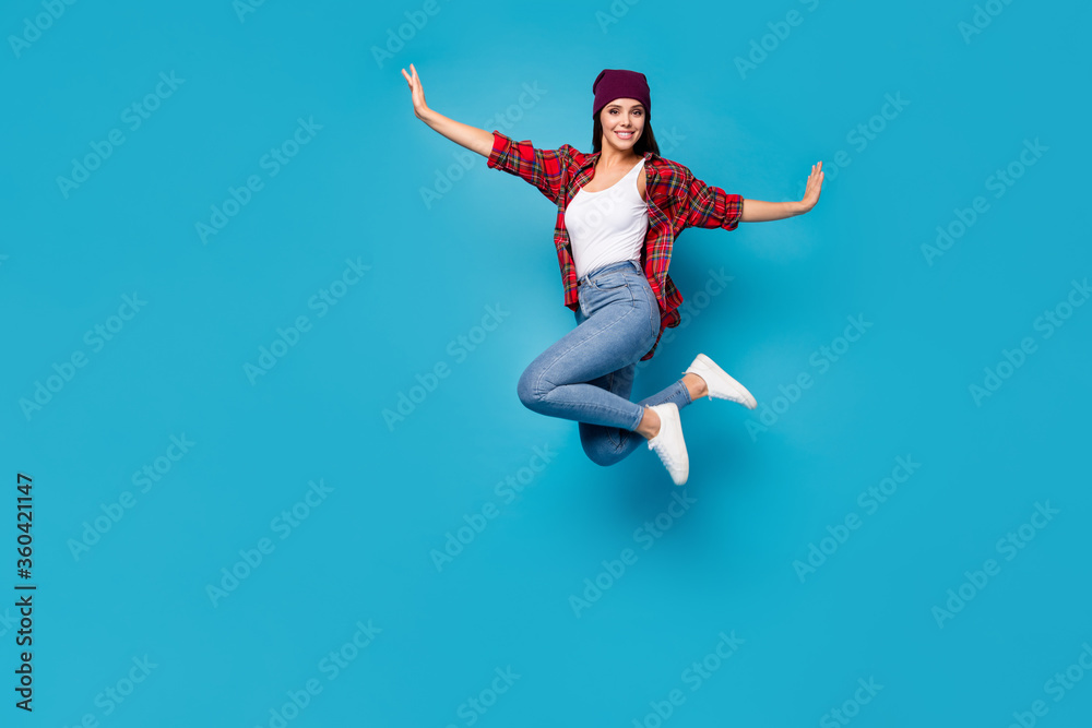 Full length body size view of her she nice attractive lovely pretty glad cheerful cheery girl jumping having fun enjoying free time isolated on bright vivid shine vibrant blue color background