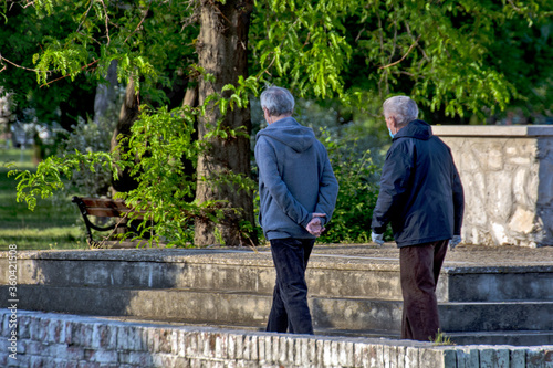 Two older men are walking