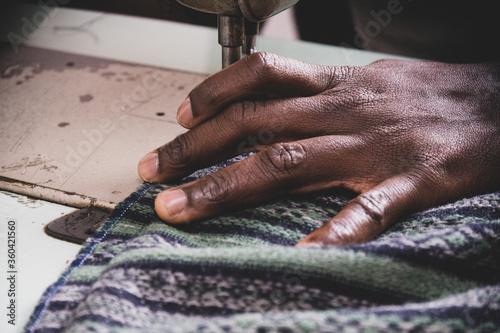 political refugees and African immigrants working on a tailoring of the no-profit association in the south of Italy, Naples.