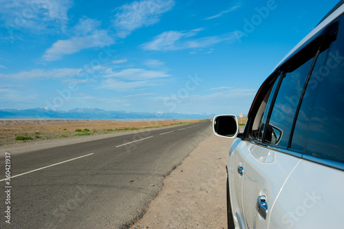 Car in mountains landscape. Road in desert