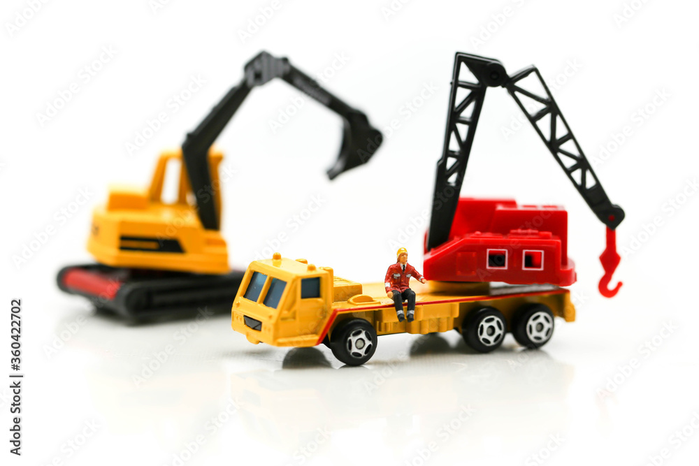 Miniature people : Group of worker and Engineer in a construction site with digger Tractor