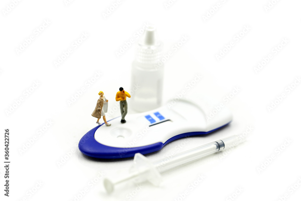 Miniature people : Couple and Doctor with Positive pregnancy test Sperm,birth of a healthy child concept. Miniature people : Couple and Doctor with Positive pregnancy test Sperm,birth of a healthy child concept.