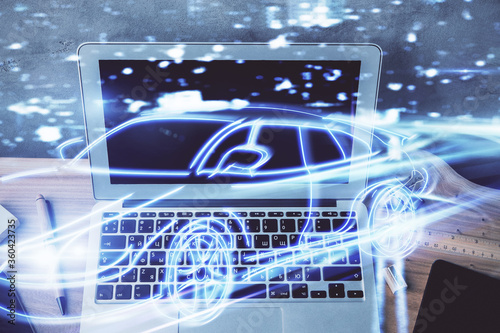 Desktop computer background in office with automobile hologram drawing. Multi exposure. Tech concept.