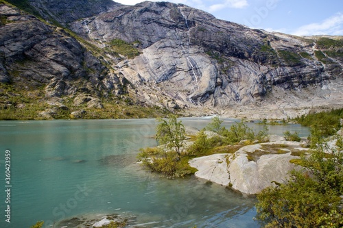 Scenic view of Nigardsbreen glacier and Nigardsbrevatnet lake surrounded by mountains - Jostedalsbreen national park, Norway