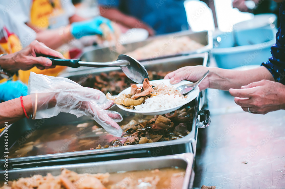The hands of beggars receive donated food : concept of charity food for the poor The hands of beggars receive donated food : concept of charity food for the poor