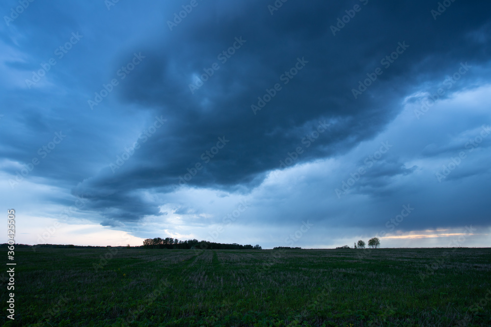 Nimbostratus Of Gray-Blue Color Over Agricultural Field In Evening Dusk In Spring.