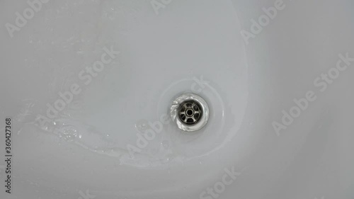 Soap water after washing hands flows down the sink. High quality 4k footage