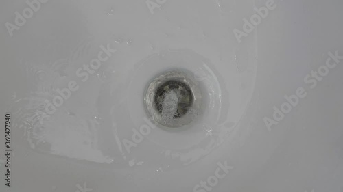 The foam water flows down the walls of the sink. High quality 4k footage