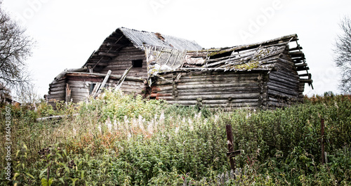 Russian old village on the edge of the forest is destroyed. North-West Russia, Wooden architecture of Karelians and Veps. photo