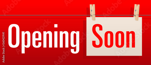 Opening soon banner for temporary showing on shopwindow and website header - red background and piece of paper hanged by clothespins to rope