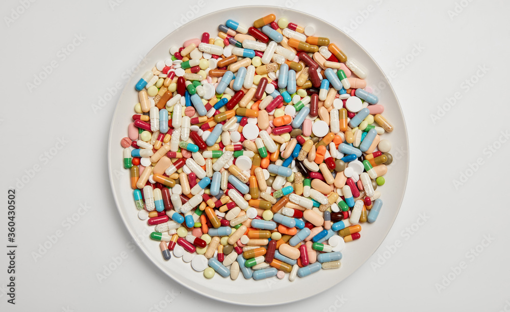 Many colorful medicines drugs on a plate