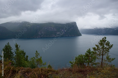 Scenic view of Norwegian coastline covered in clouds