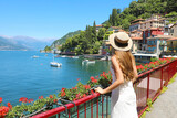 Holidays on Lake Como. Back view of beautiful fashion girl enjoying view of the Walk of Lovers in Varenna, Lake Como. Summer vacation in Italy.