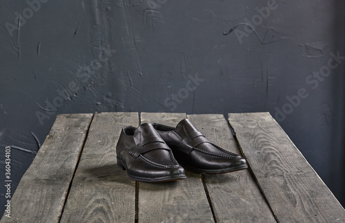 black loafers on a wooden