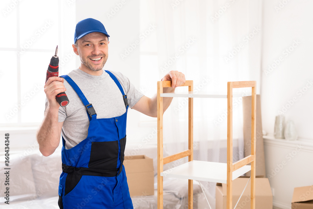 Handyman Posing Installing Furniture Holding Electric Drill Standing Indoors Handyman Posing Installing Furniture Holding Electric Drill Standing Indoors