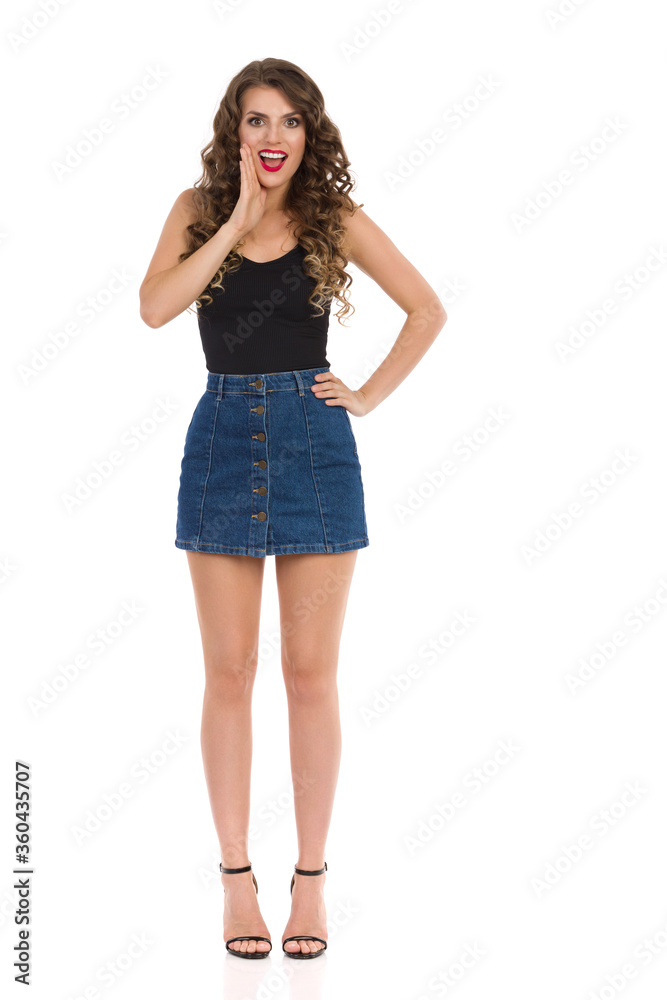Sexy Woman In Jeans Mini Skirt And High Heels Is Talking With Hand On Chin Sexy Woman In Jeans Mini Skirt And High Heels Is Talking With Hand On Chin