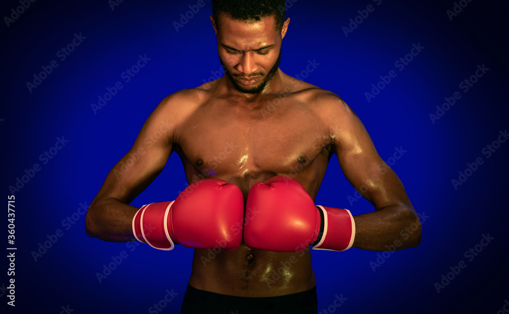 Black Boxer Guy Posing Wearing Gloves Over Blue Background