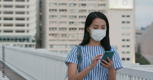Photography Woman wear face mask and use of mobile phone in city