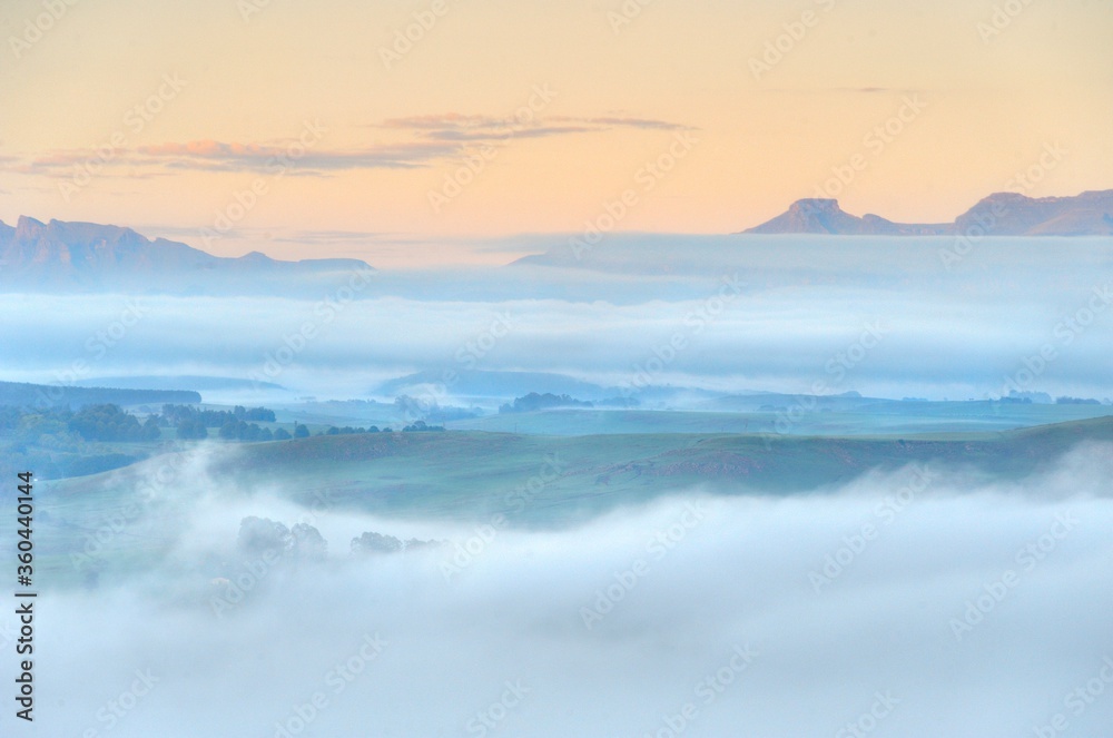 FOG BANKS collect in the valleys between foothills of the Drakensberg mountains, kwazulu Natal, south Africa FOG BANKS collect in the valleys between foothills of the Drakensberg mountains, kwazulu Natal, south Africa