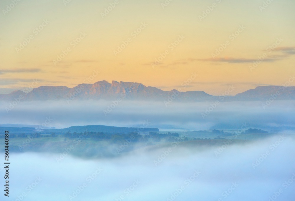 FOG BANKS collect in the valleys between foothills of the Drakensberg mountains, kwazulu Natal, south Africa