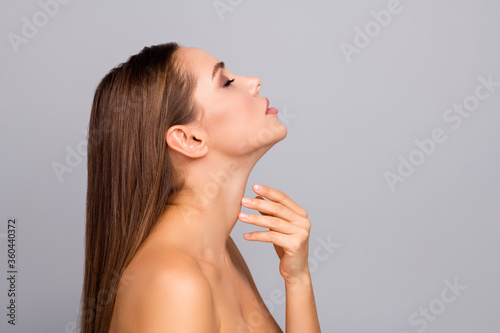 Profile side photo of charming gorgeous lady enjoy her skincare procedure smooth natural ideal skin touch chin neck close eyes isolated over grey color background