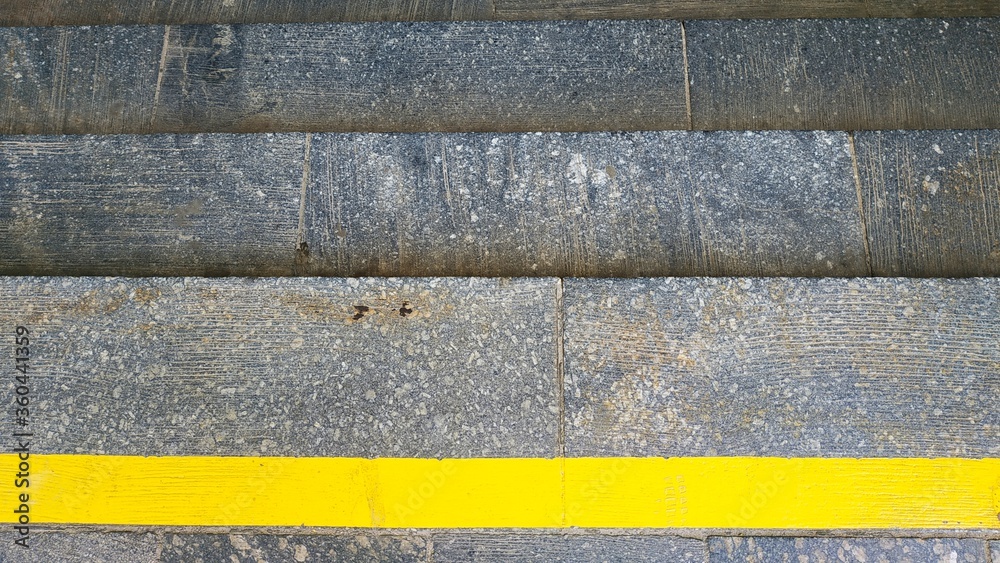 Close-up steps with a bright yellow protective line Close-up steps with a bright yellow protective line