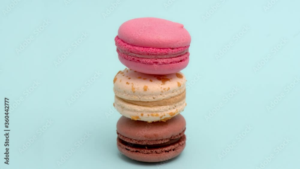Stop motion animation of colorful macarons on blue