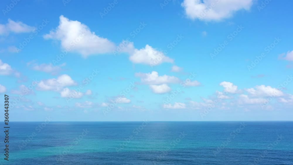 Aerial view of clear Ocean water with blue cloudy sky. Aerial view of clear Ocean water with blue cloudy sky.