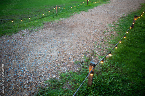 Wallpaper Mural Gravel walking path in a grass field/lawn with light bulb fence Torontodigital.ca