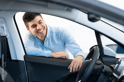 Happy Man Choosing New Auto In Dealership Store © Prostock-studio