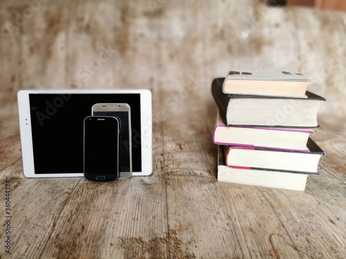 Books vs smartphones. Technology or books ?. Traditional or modern information? Comparison photo