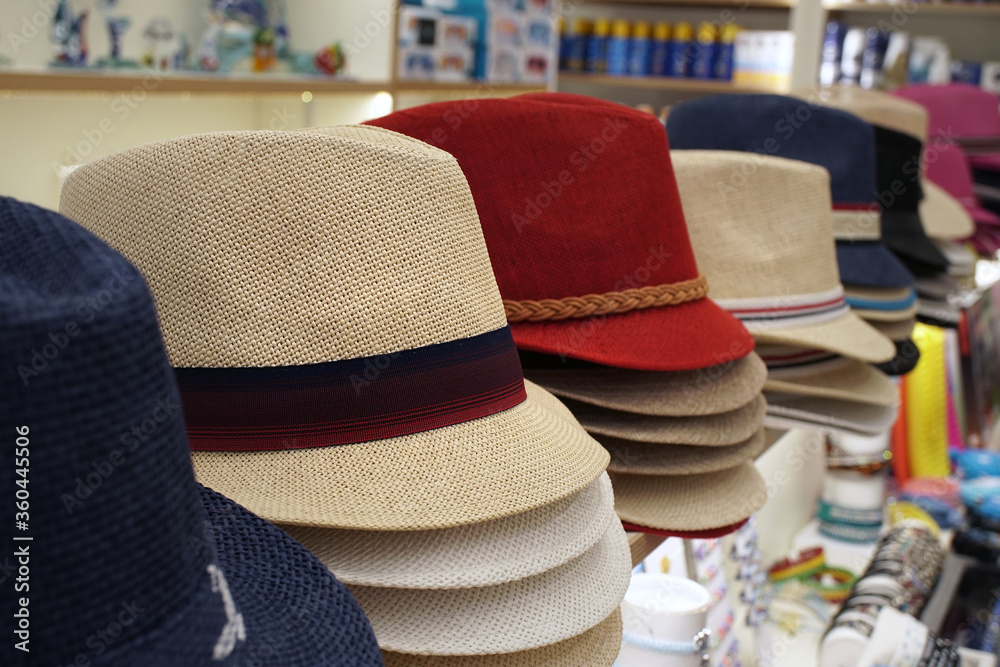men's summer hats of various colors in a souvenir shop