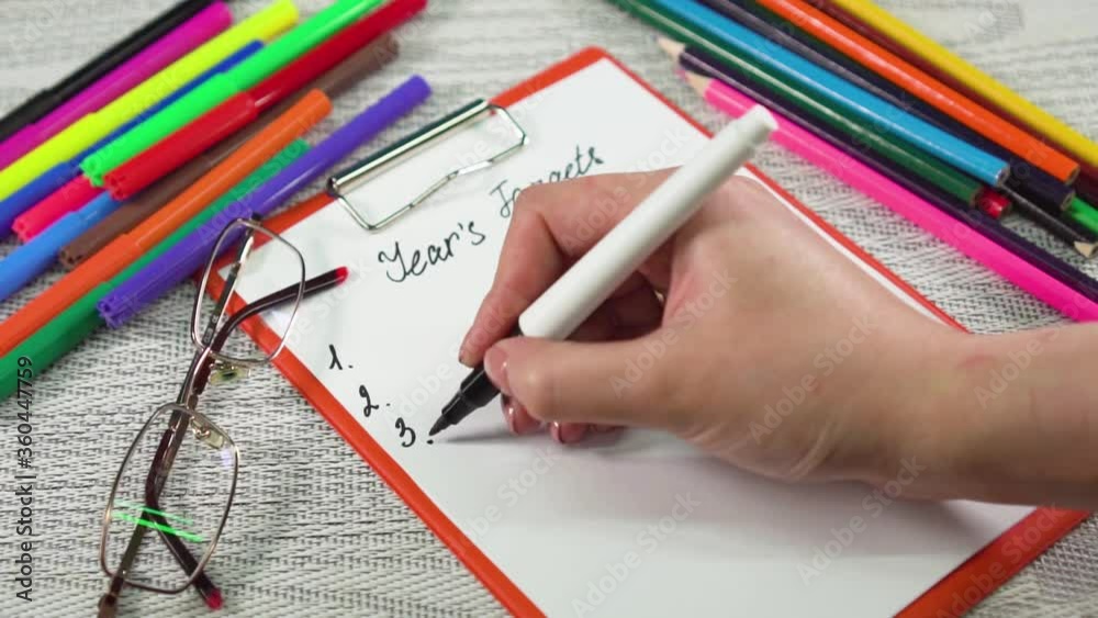 girl puts a dot on the tablet with the inscription years targets girl puts a dot on the tablet with the inscription years targets