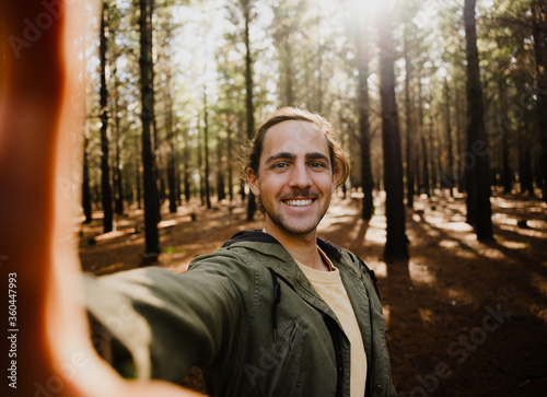 Self portrait of young happy male in the woods, selfie