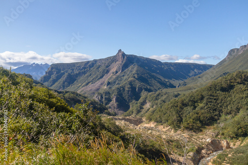 Daytime view in clear sunny weather of hills  rivers  mountains  forests  mountainous terrain.