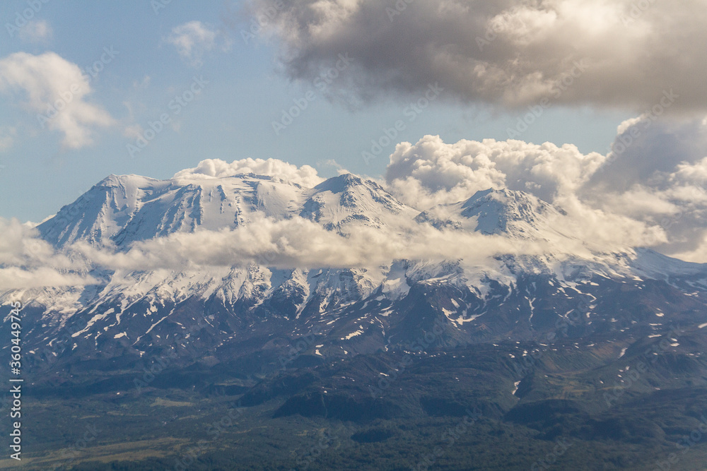 Fototapeta premium Daytime view in clear sunny weather of the snow-capped mountain peaks