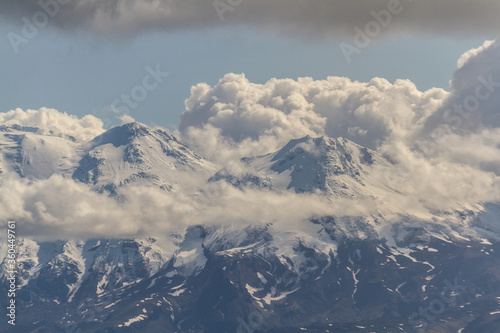 Daytime view in clear sunny weather of the snow-capped mountain peaks
