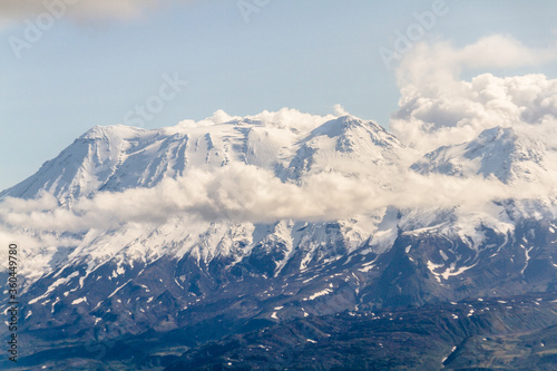 Daytime view in clear sunny weather of the snow-capped mountain peaks
