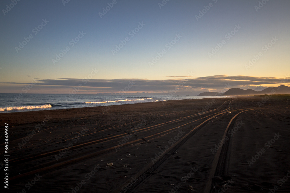 Fototapeta premium View of the Pacific coast during a sunny sunset on a clear sunny day.