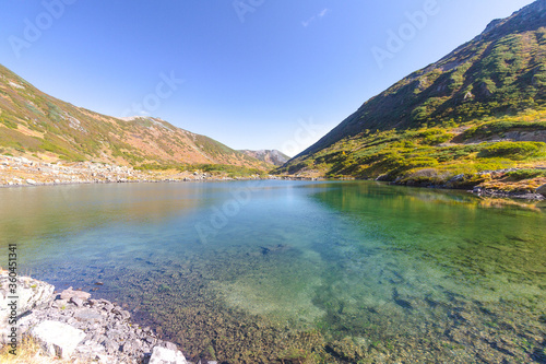 Daytime view in clear sunny weather of the snow-capped mountain peaks