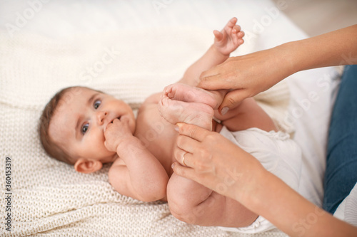 Close-up of children's foot massage on the bed.