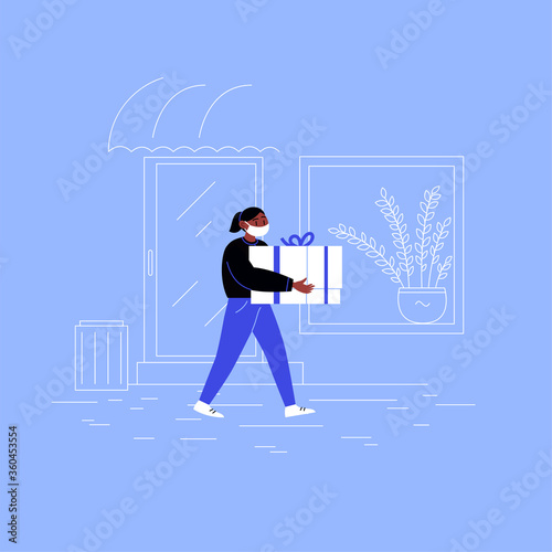 Delivery girl on her way to a client with a box walking down the street wearing medical face mask