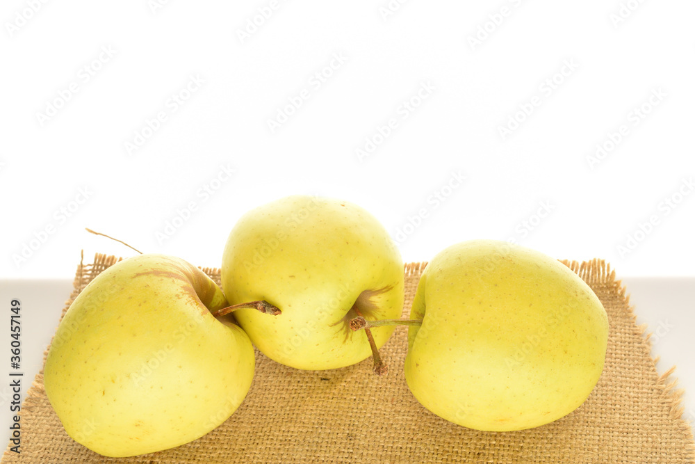 Yellow apples, close-up, on a white background.