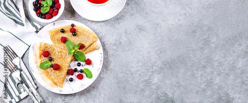 Delicious Crepes Breakfast. Orthodox Holiday Maslenitsa. Pancakes with berry currant, raspberry